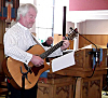 Andrew tunes up his guitar for the service